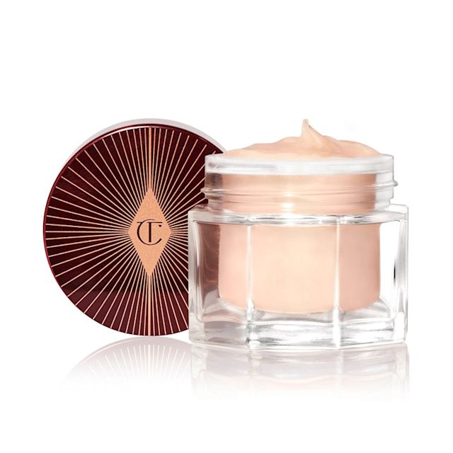 Magic Night Cream open packshot for blog A thick and luscious dark champagne-coloured face cream in an open glass jar with a black and gold coloured lid next to it.