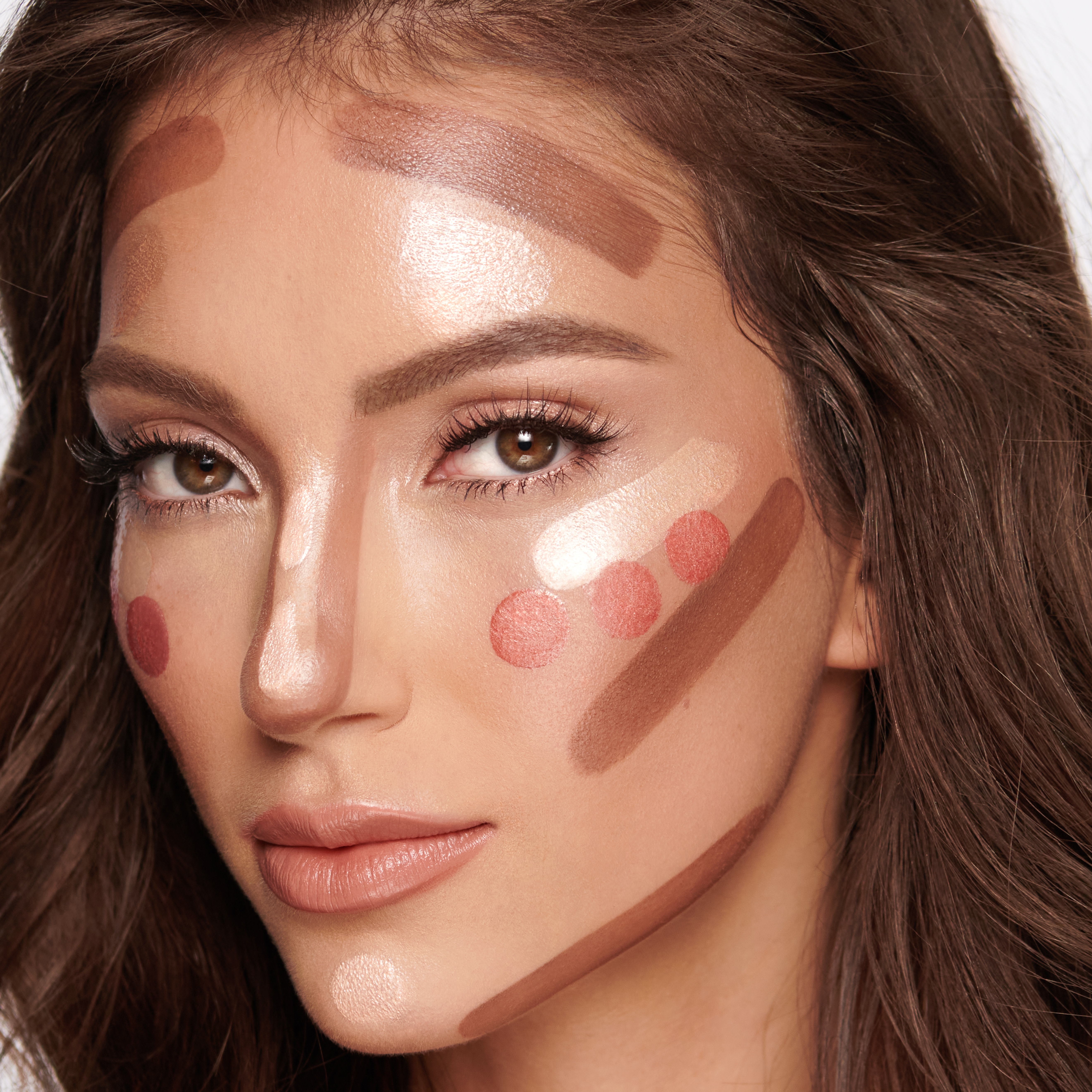 A medium-tone model with unblended liquid contour, blush, and highlighter.
