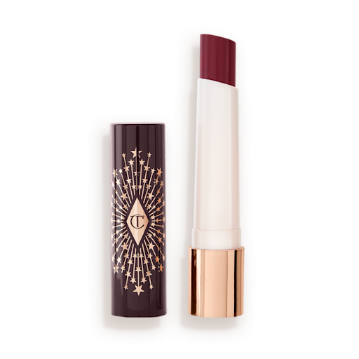 Hyaluronic Happikiss in Happiberry lid removed An open lipstick lip balm in a berry shade, in white and gold tube with a black-coloured lid with gold sparkles all over it.