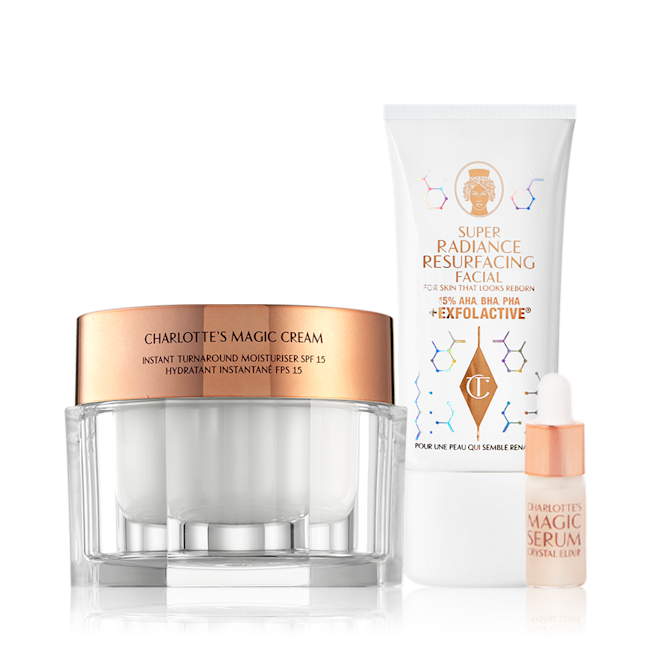 Gleaming Glowing Skin Duo Thick, pearly-white cream in a glass jar with a gold-coloured lid with an exfoliating, wash-off mask in a white-coloured tube, and a sample-size face serum in a small bottle with a dropper lid.