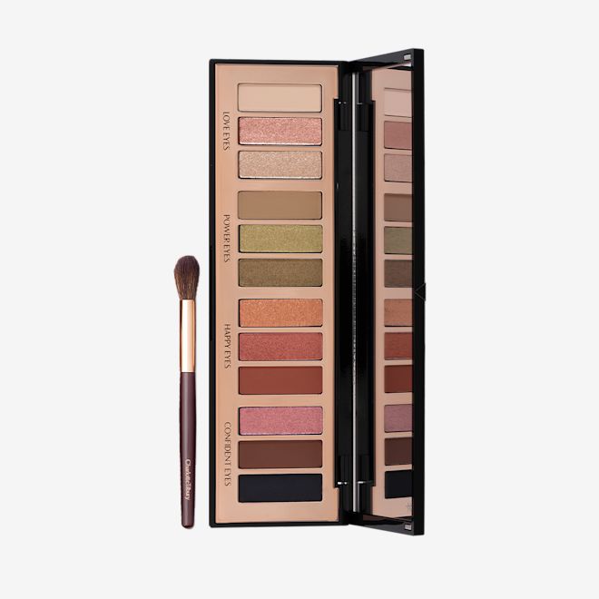 Instant Smokey Eyes Duo open Eyeshadow blending brush in a dark brown and gold colour scheme with an open, 12-pan eyeshadow palette with a mirrored-lid with pink, gold, green orange, red, brown, black, and beige shades to create different smokey eye looks.