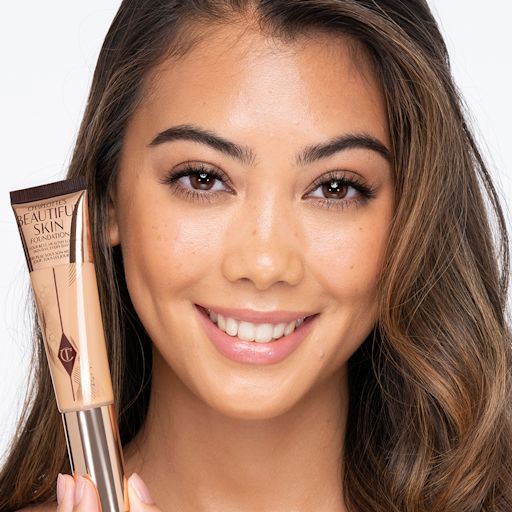Beautiful Skin foundation in 7W on medium-light-tone model Medium-light-tone brunette model wearing glowy, skin-like foundation with a fresh, satin finish with a nude lipstick, and subtle eye makeup. view 2