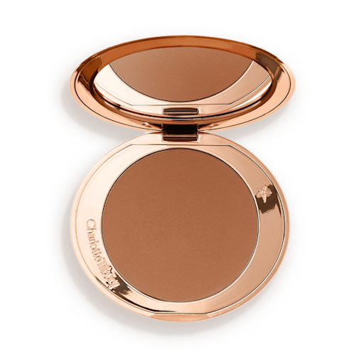 Airbrush Bronzer in Tan open An open mirrored-lid bronzer compact in a tan shade.