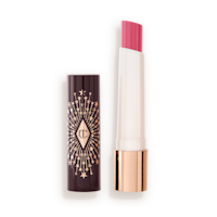 Hyaluronic Happikiss in Crystal Happkiss lid removed An open lipstick lip balm in a sheer nude pink berry shade, in white and gold tube with a black-coloured lid with gold sparkles all over it.
