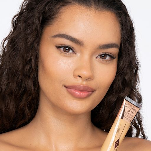 Beautiful Skin foundation in 8 Neutral on medium-dark-tone model A medium-dark-tone brunette model wearing glowy, skin-like foundation that covers her blemishes and gives the appearance of clean, bouncy, and fresh skin.