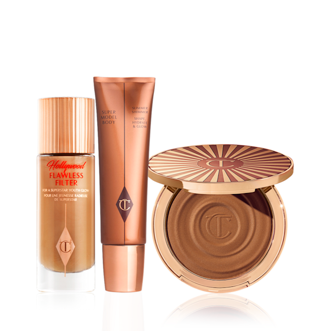 Bronze Glow Head-to-Toe Kit Glowy primer in a frosted glass bottle with a gold-coloured lid, body highlighter wand, and cream bronzer compact.