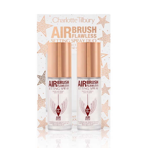 Airbrush Flawless Setting Spray Duo with box Two, identical, mini setting sprays with gold-coloured lids and their white and gold-coloured packaging box behind them with gold stars printed all over with text on the box that reads, 'Charlotte Tilbury. Airbrush Flawless Setting Spray duo'