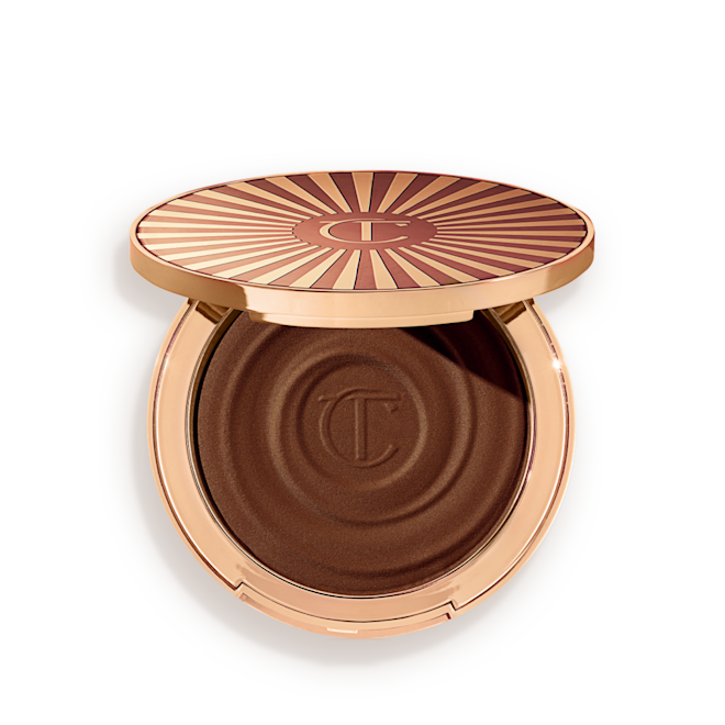 Beautiful Skin Sun-Kissed Glow Bronzer in Deep open Open, cream bronzer compact in a black-brown shade with gold-coloured packaging.