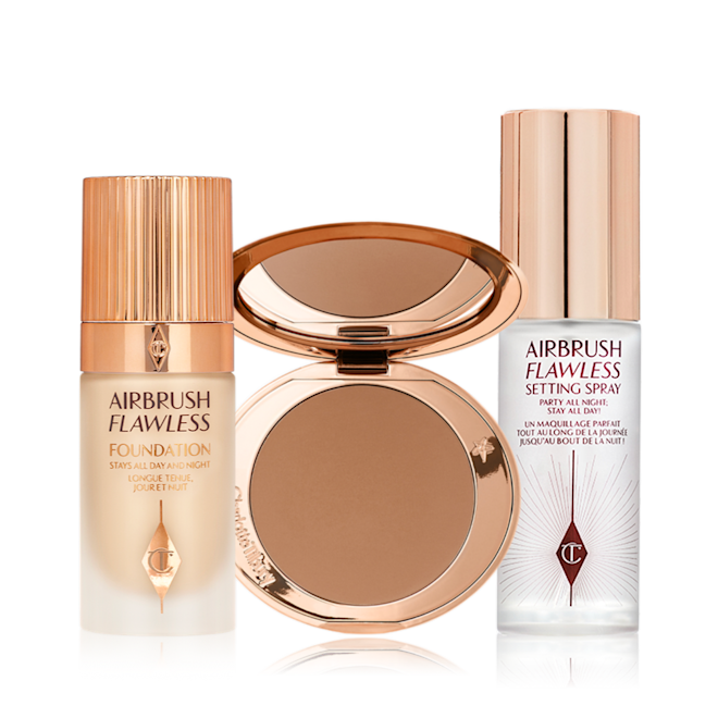 The Famous Airbrush Flawless Routine Kit open A foundation in a glass bottle with a gold-coloured lid, bronzer compact in a medium-brown shade, and setting spray with a gold-coloured lid.