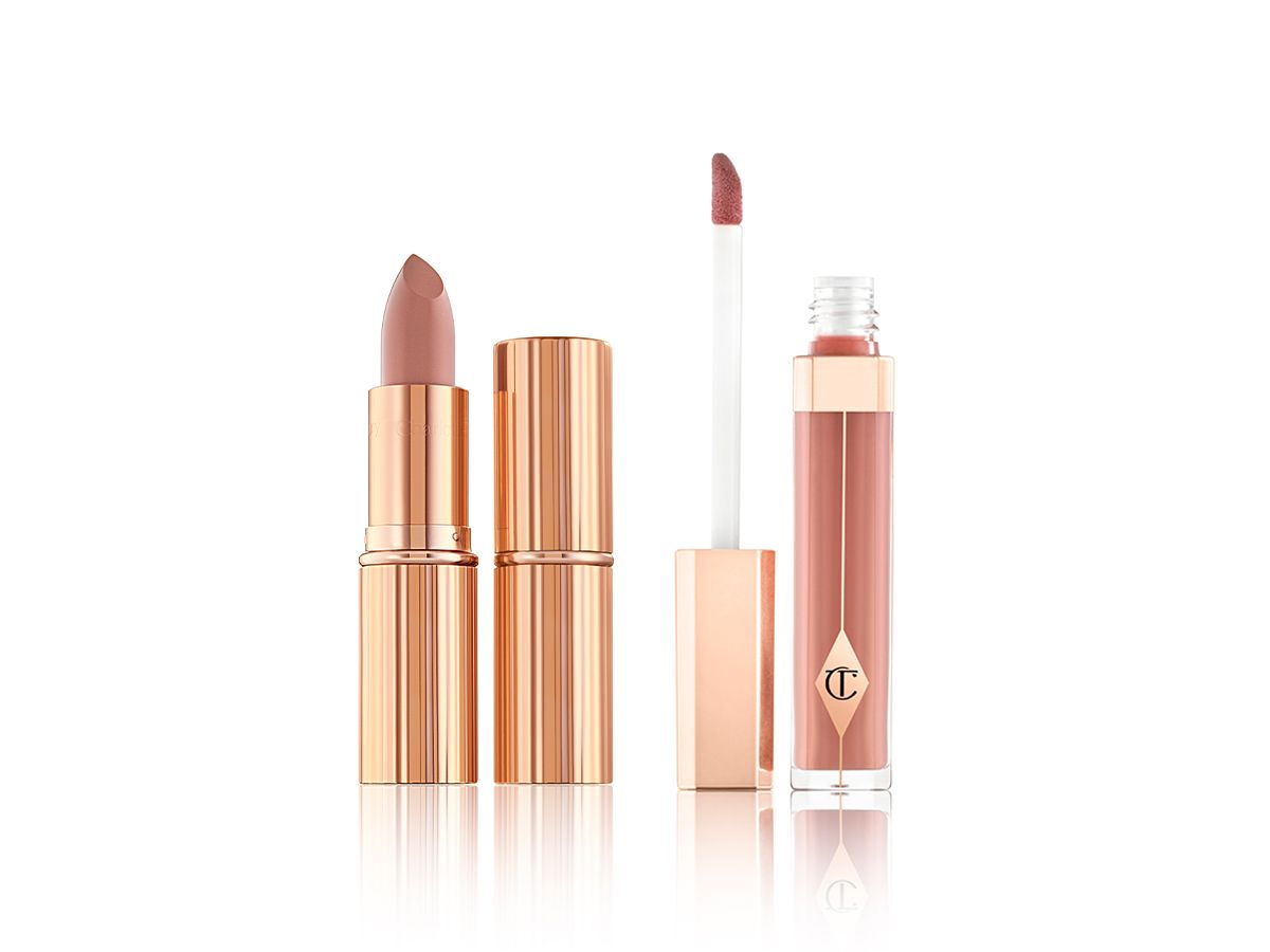 Lip Lustre in Seduction and KISSING in Penelope Pink open Two lipsticks, with and without lid in a nude brown shade with a nude pink-brown lip gloss with its doe-foot applicator next to it.