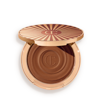 Beautiful Skin Sun-Kissed Glow Bronzer in tan open Open, cream bronzer compact in a dark-brown shade with gold-coloured packaging.