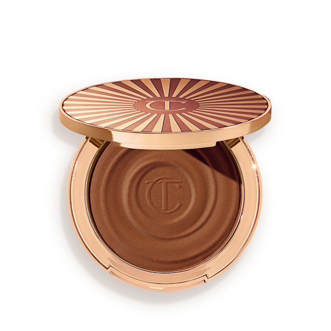 Beautiful Skin Sun-Kissed Glow Bronzer in tan open Open, cream bronzer compact in a dark-brown shade with gold-coloured packaging.
