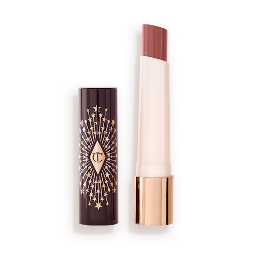 Hyaluronic Happikiss in Pillow Talk lid off An open, moisturizing lipstick lip balm in a nude pink shade with a black and gold-coloured cover.