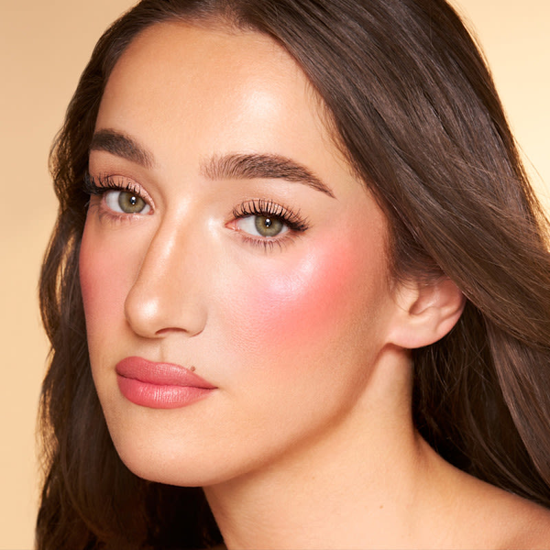 Bella Paradise Pink Bella wearing a bright pink summer blush look created with Paradise Pink Glow