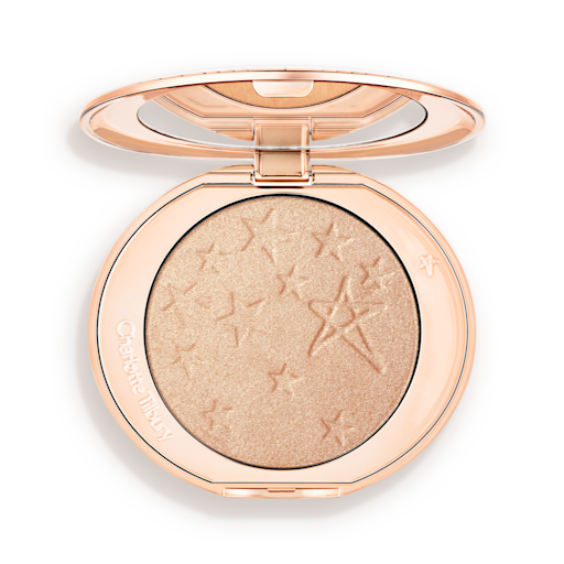 Hollywood Highlighter in Champagne Glow open An open highlighter powder compact with a mirrored lid, in a shimmery champagne shade.