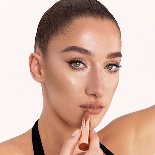 Matte Revolution The Super Nudes in Catwalking on fair-tone model Light-tone model with blue eyes wearing soft beige and champagne eyeshadow with a fresh, neutral nude peach lipstick with a matte finish. view 2