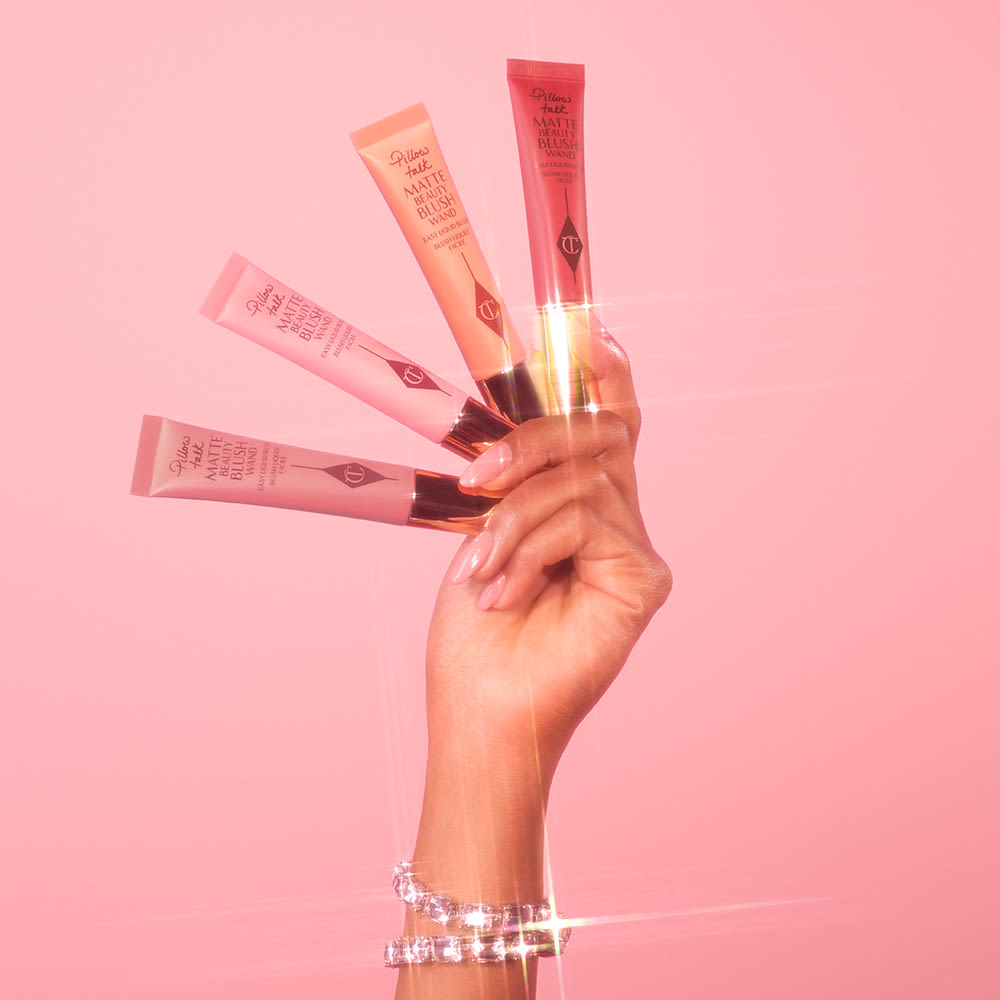 Beauty Blush Wand hand model shot Hand close up holding all four shades of Charlotte's new Pillow Talk Matte Beauty Blush Wands