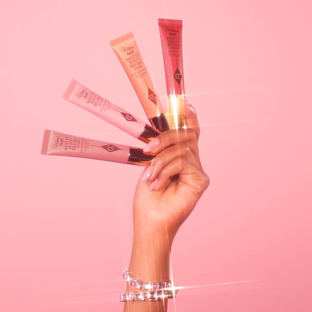 Beauty Blush Wand hand model shot Hand close up holding all four shades of Charlotte's new Pillow Talk Matte Beauty Blush Wands