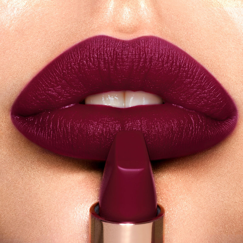Lips close-up of a light-tone model wearing muted purple berry lipstick with subtle cool-tones and a matte finish.