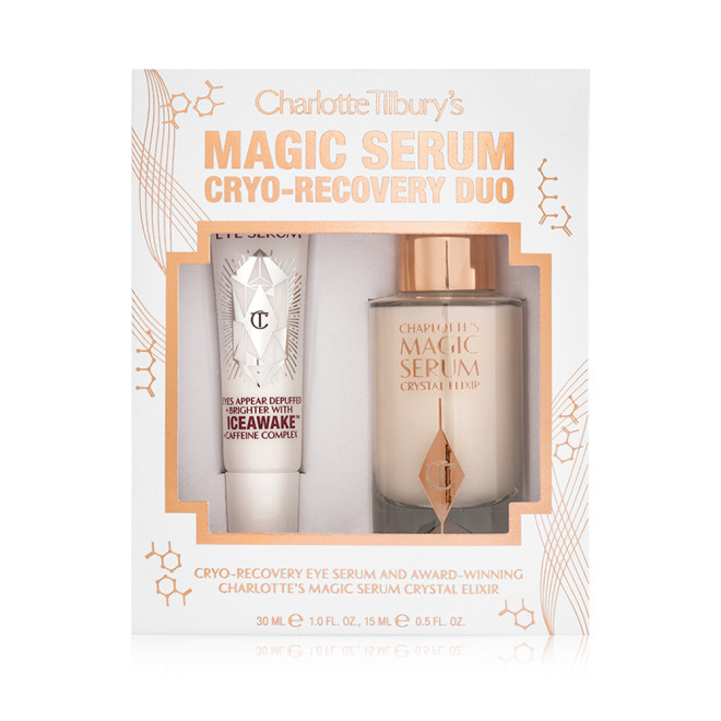 Eye serum in a white-coloured tube with geometric patterns on the front in a reflective, silver colour along with luminous, facial serum in a glass bottle with a white and gold dropper lid in a white and gold-coloured packaging box with text on it that reads, 'Magic serum cryo=recovery duo'