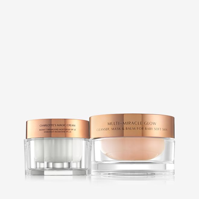 Multi Miracle Glow and Magic Cream closed Pearly-white face cream in a glass jar with a gold-coloured lid and a three-in-one cleansing balm in a glass jar with a gold-coloured lid.