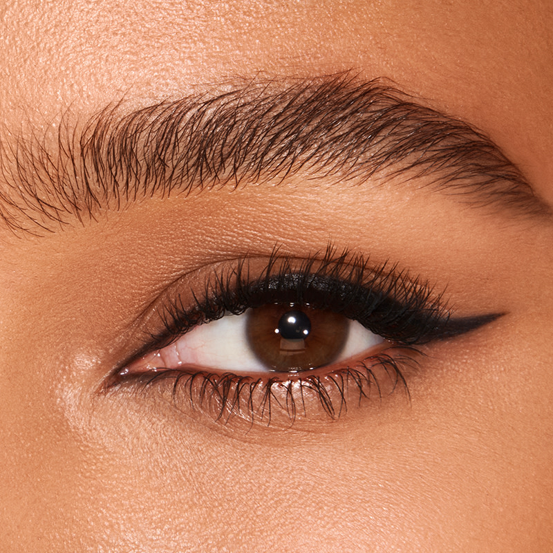 Eye close-up of a brown eye with jet-black winged liner using liquid eyeliner.
