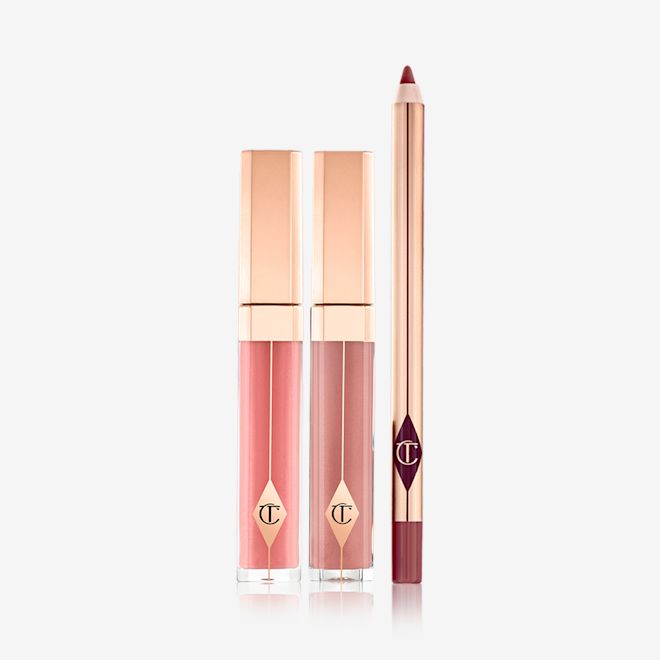 Pout Perfection Lip Kit displayed Tow lip glosses in gold-coloured packaging in a nude pink and mauve shades with a lip liner pencil in a maroon shade.