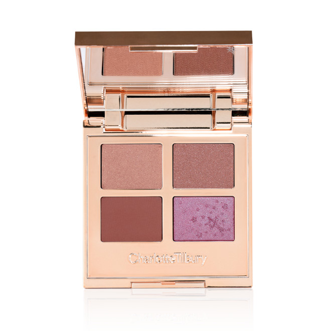 An open, quad eyeshadow palette with a mirrored-lid wth eyeshadows in shades of peachy-pink, dusky rose, warm burgundy, and teal blue-brown.