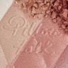Pillow Talk Multi-Glow highlighter in Romance Light swatch close-up Close-up swatch of a pressed powder highlighter compact in various shades of pink and gold for cool-tone complexions.