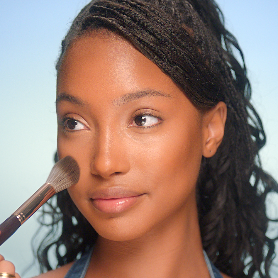 2000s makeup tutorial step 4 - set with powder model with mattified skin having makeup powder applied to her cheek