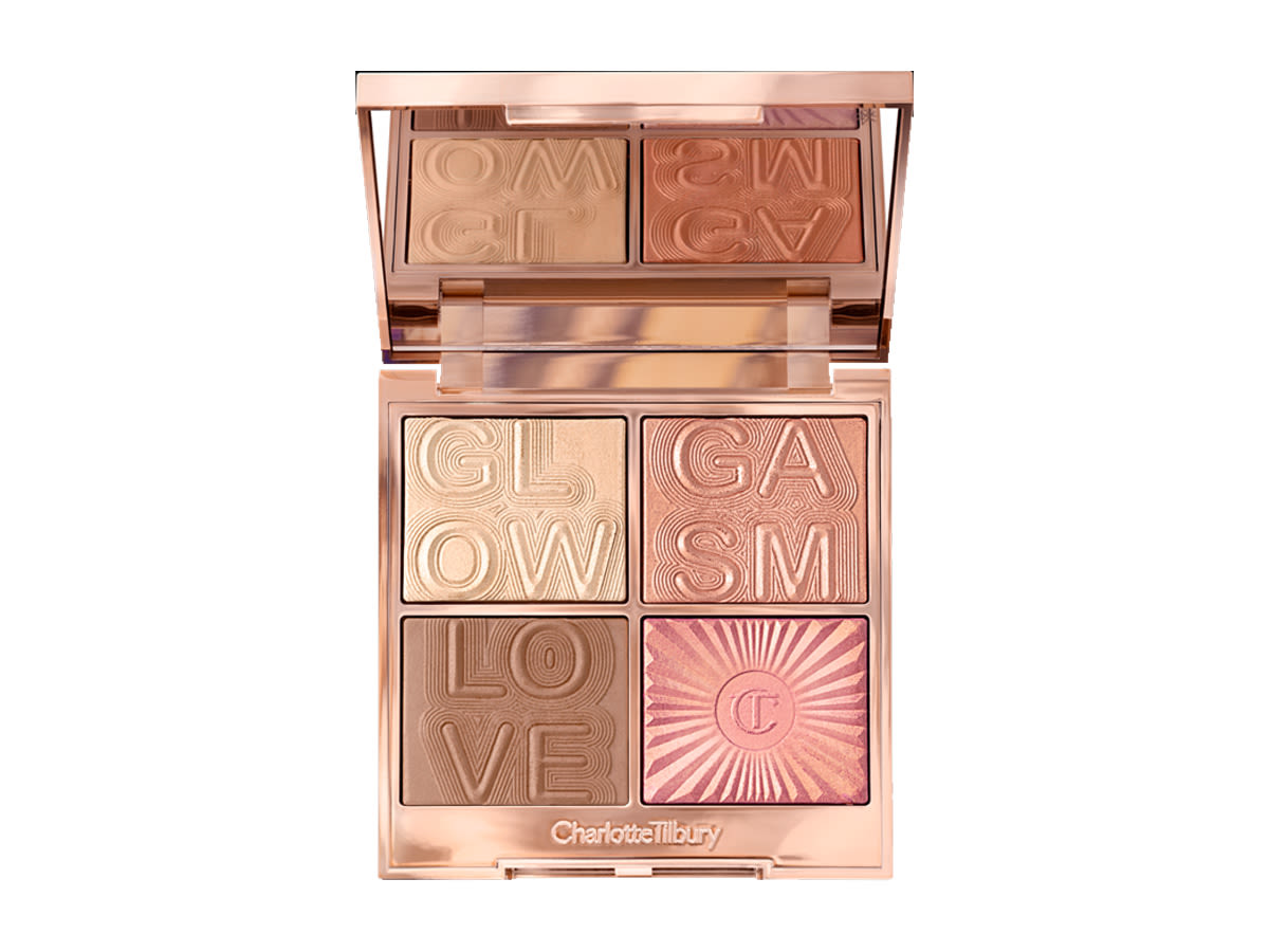 Glowgasm Palette in Lightgasm open An open, mirrored-lid face palette with a light brown bronzer, a warm-pink glowy blush, and two mega-watt highlighters in terracotta and champagne shades.