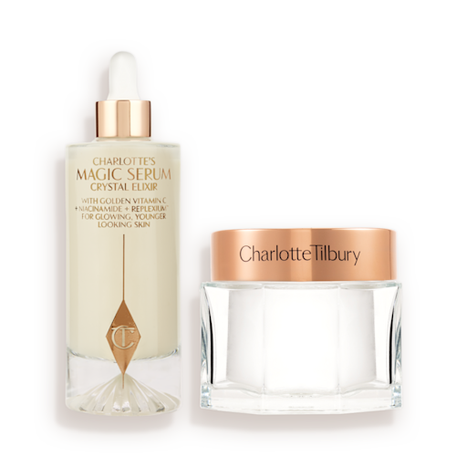 Supersized Magic Skin Duo closed A large serum in a glass bottle with a golden and white-coloured dropper lid and pearly-white face cream in a glass jar with a rose-gold-coloured lid.