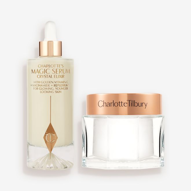 Supersized Magic Skin Duo closed A large serum in a glass bottle with a golden and white-coloured dropper lid and pearly-white face cream in a glass jar with a rose-gold-coloured lid.