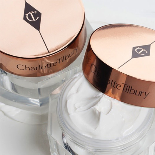 Pearly-white face cream duo in glass jars with gold-coloured lids with the iconic CT logo on them.