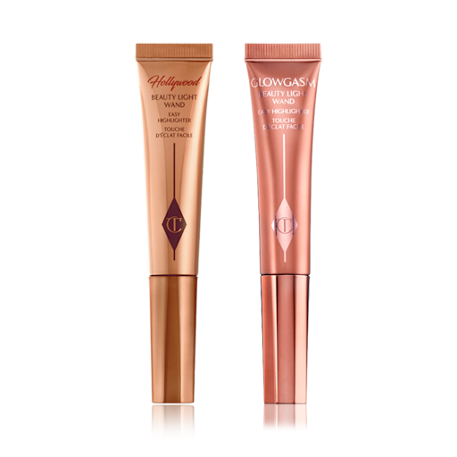 Beauty Light Wands duo closed A highlighter wand and a highlighter blush wand with reflective packaging in rose gold and honey-gold shades.