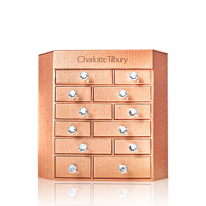 Charlotte's Bejewelled Chest of Beauty Treasures closed A golden-coloured chest of drawers with Charlotte Tilbury written on top.