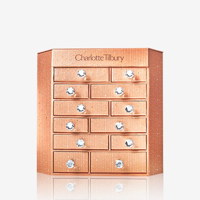 Charlotte's Bejewelled Chest of Beauty Treasures closed A golden-coloured chest of drawers with Charlotte Tilbury written on top.