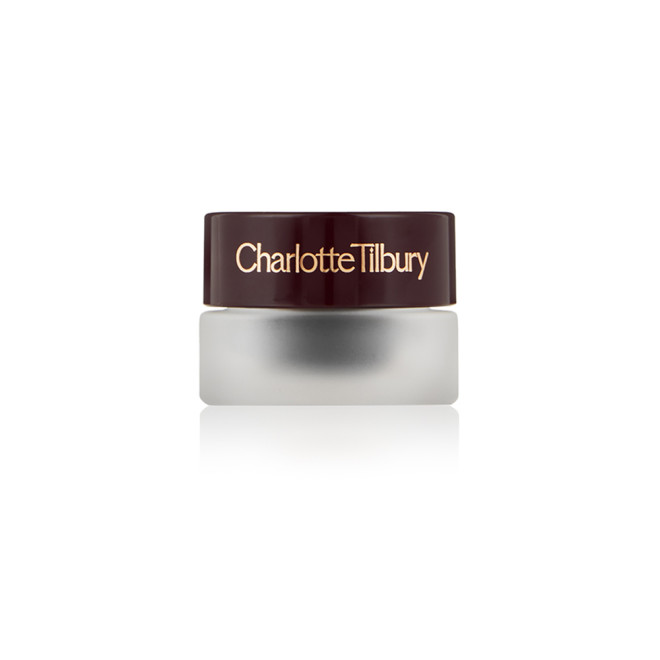 Frosted glass pot with a cream eyeshadow in a jet-black shade with a dark brown lid with Charlotte Tilbury written on the lid in gold. 