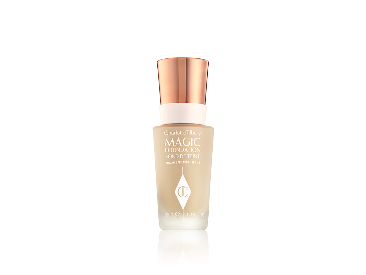 Magic Foundation still life A light beige-coloured foundation in a frosted glass bottle with the CT logo printed on it and a rose gold coloured lid.