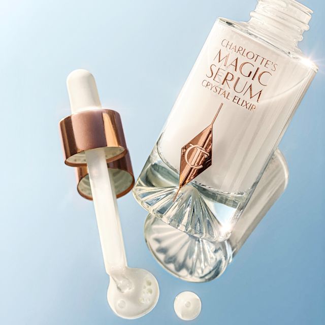 Magic Serum open still life Charlotte's Magic Serum Crystal Elixir releasing drops of face serum