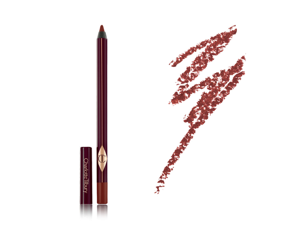 Walk of No Shame Eyeliner with swatch An open eyeliner pencil with its lid next to it in dark crimson packaging along with its dark coppery-red swatch.