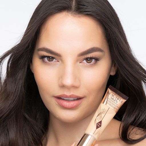 Beautiful Skin Foundation in 5N on medium-light-tone model after application Medium-light-tone brunette model wearing glowy, skin-like foundation with a satin finish with nude lipstick and subtle eye makeup.