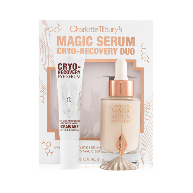 Eye serum in a white-coloured tube with geometric patterns on the front in a reflective, silver colour along with luminous, facial serum in a glass bottle with a white and gold dropper lid with their packaging box behind them.