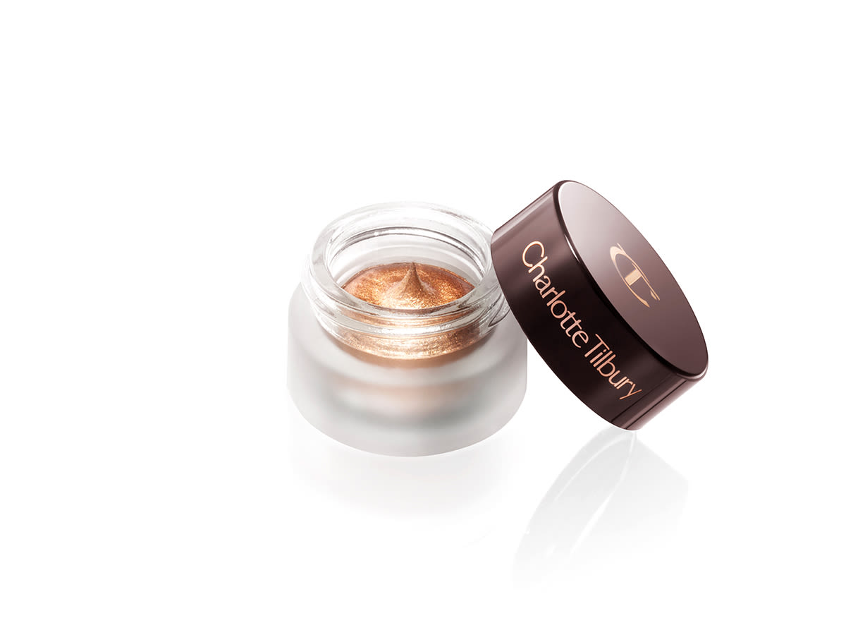 Eyes to Mesmerise in Star Gold open A dark bronze-gold cream eyeshadow in an open glass pot with a dark brown-coloured lid.