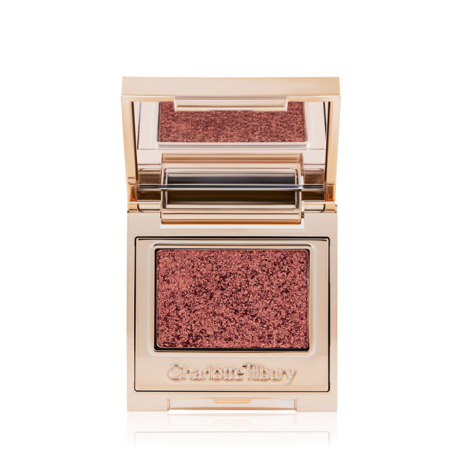 An open, single-pan eyeshadow with a mirrored lid in an iridescent rustic red shade with very fine shimmer. 