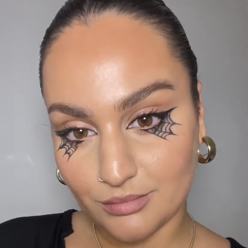 Model wearing a spider web Halloween eyeliner look