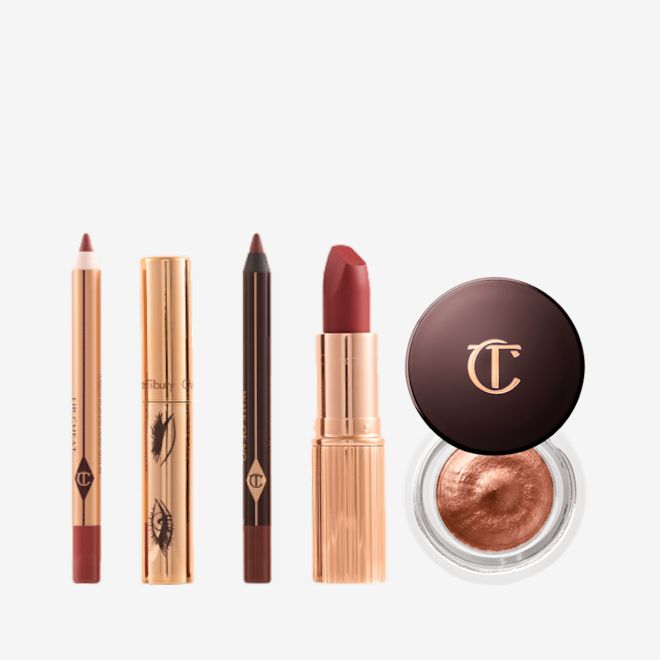 Walk of No Shame Eye Lip Icons An open lip liner pencil in berry rose, mascara in a gold-coloured tube, lip liner pencil in a berry rose shade, matte lipstick in a berry red shade in a gold-coloured tube, and cream eyeshadow in a russet rose shade with gold sparkle.