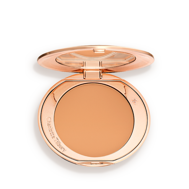 Airbrush Flawless Finish in tan open An open, pressed powder compact in a sandy-brown shade.