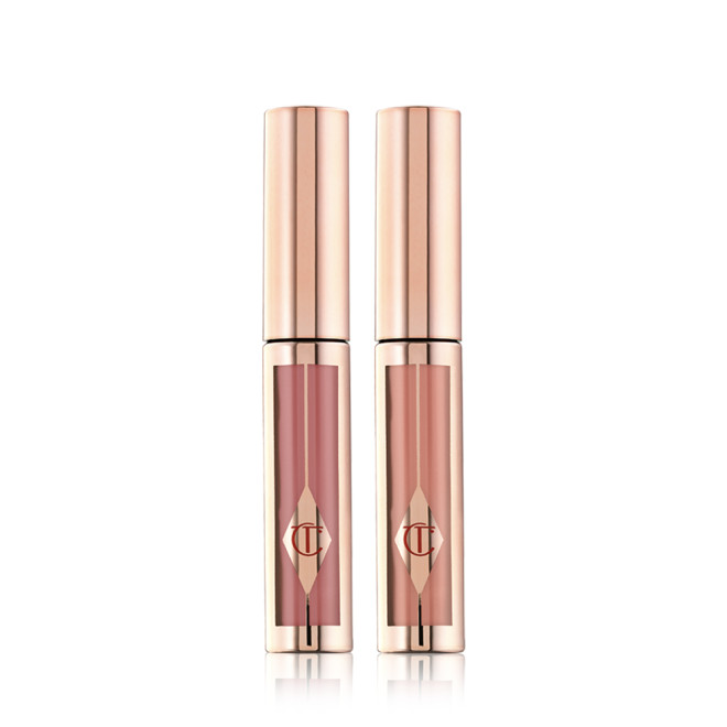 Two, closed liquid lipsticks in a gold colour scheme in shades of nude peach-brown, and nude rose-brown. 