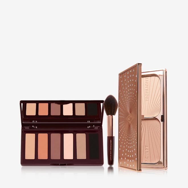Super Nudes Bronze Glow Kit An open 6-pan matte eyeshadow palette with nude brown, peach, beige, and black shades, a contouring and bronzing fluffy brush, and a duo contour palette in sleek gold-coloured packaging.
